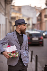 stylish man goes to a meeting with gifts
