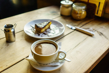 Coffee Americano with hot milk, chocolate cheesecake