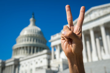 Hand of protestor holding up a peace sign gesture in front of the Capitol Building in Washington,...