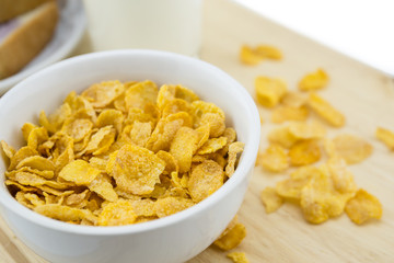 Golden Cornflakes (detailed close-up shot) on an old wooden table