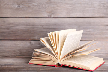 Open book on a grey wooden table