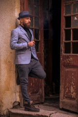 stylish man with a beard in a hat on the street