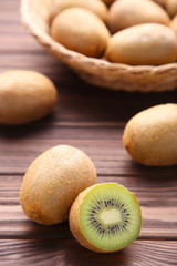 Kiwi in a basket on brown background