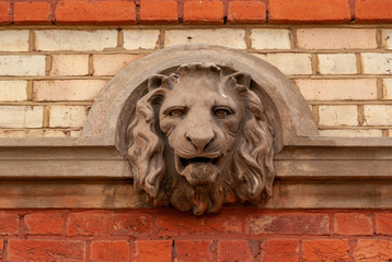 Lion head bust sculpture detail in wall
