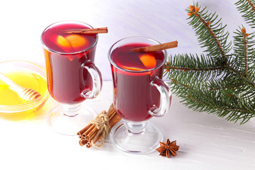 Mulled wine on white background. Christmas mulled wine, cinnamon sticks, anise and honey. Alcoholic...