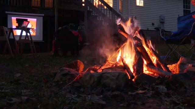 Family Bonfire And Movie Night In Backyard Of House