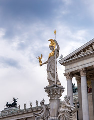Sculpture of Pallas Athena, the Greek goddess of wisdom against the Austrian Parliament Building in...