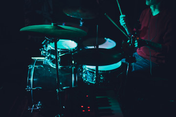 Obraz na płótnie Canvas Modern drum set shot in smoky dark studio.