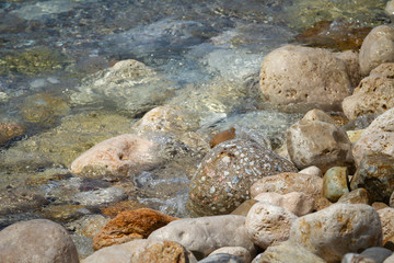 Sea colored stones in the transparent water