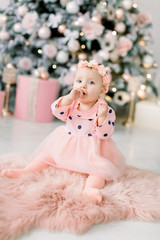 Fototapeta premium house. bedroom. room a little girl. Very beautiful girl playing on the floor. Xmas holiday concept