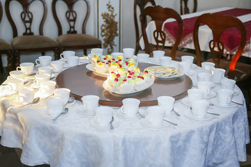Tea mugs and cake on the table