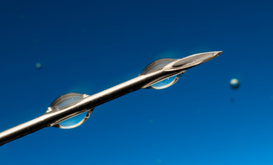 Medical syringe on blue color background close up