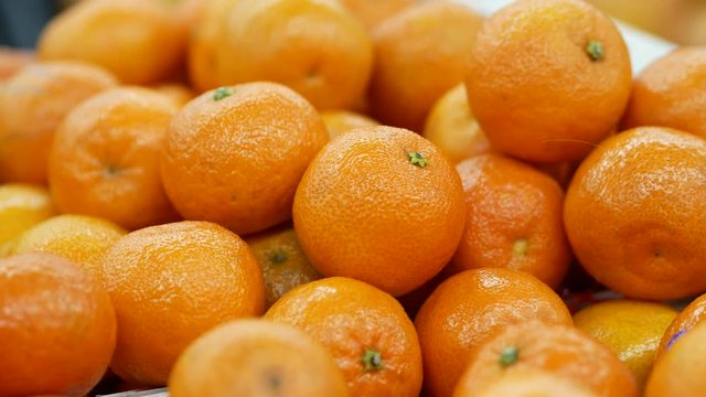Harvest of mandarins on the store counter. Close up