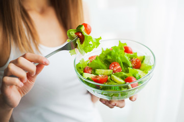 Diet and Healthy eating. Young woman eating healthy salad after workout