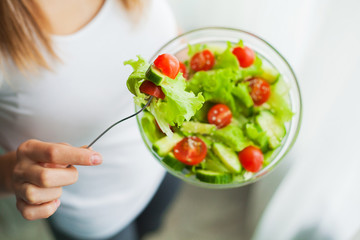 Diet and Healthy eating. Young woman eating healthy salad after workout