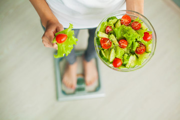Diet and Healthy eating. Young woman eating healthy salad after workout