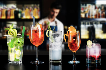 selection of mixed cocktail drinks alcohol various garnish bar hotel craft bartender background