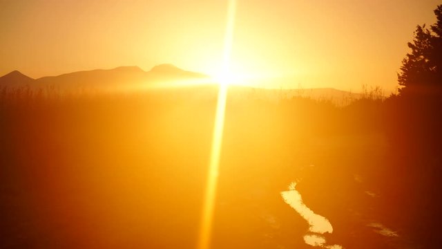 Scenic sunrise sun rising over mountain hill, time lapse