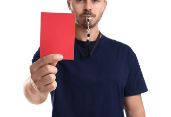 Football referee with whistle holding red card on white background, closeup