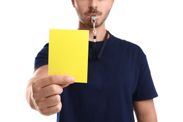 Football referee holding yellow card on white background, closeup