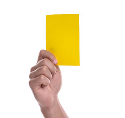 Football referee holding yellow card on white background, closeup