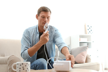 Man using asthma machine at home. Health care