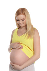 Beautiful pregnant woman showing her tummy on white background