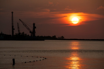 Sunset over Industrial Plant on the Waterfront in Bahamas