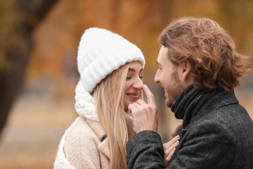 Fototapeta premium Young romantic couple in park on autumn day
