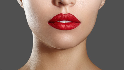 Fashion Red Lip Makeup. Bright Lipstick on Lips. Closeup of Beautiful Female Mouth. Part of Woman...