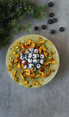 Vegan raw cheesecake with blueberry, cherry, matcha tea, orange,  cashew cream, coconut butter and coconut milk, and base made of almonds, dates  and  dried apricots, oat flakes, lyophilisated berry