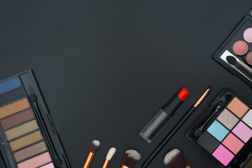 make up  and brushes  on black background