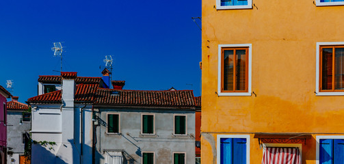 Yellow and blue colorful houses on the island of Burano, Venice, Italy