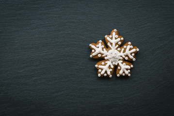 Gingerbread snowflakes of dough with icing sugar to decorate the holiday table.