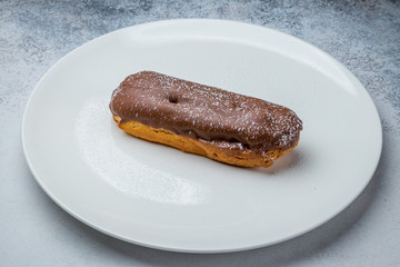 chocolate Eclair on a white plate