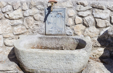 Historical fountain still working at the foot of Castel di Tora. Lake Turano, Lazio, Italy.