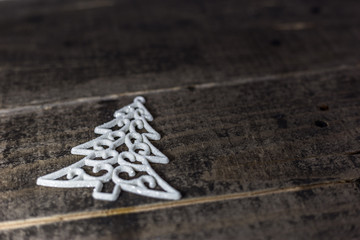 Christmas tree ornament on the old wooden floor. Winter holidays background with empty space for text.