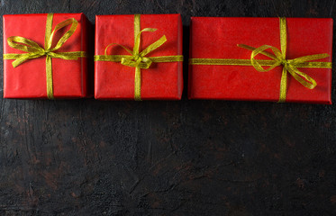 Christmas background with decorations and gift boxes on black background. Top view