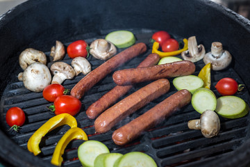 sausages and vegetables on the grill