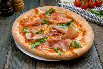 Pizza with Parma ham and arugula