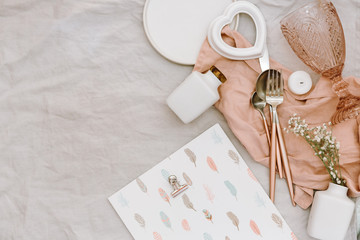 Flat lay Wedding or festive table setting. Plates and cutlery with gray decorative textile on white background. Beautiful arrangement.
