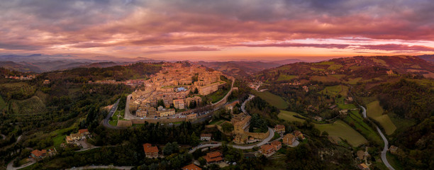 Aerial panorama with colorful sunset sky of the Ducal Palace and city walls at the popular tourist...