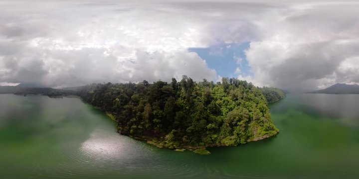 aerial vr360 mountain lake Buyan with slopes covered tropical vegetation. Bali Landscape, lake among mountains, sky, clouds. Aerial footage.