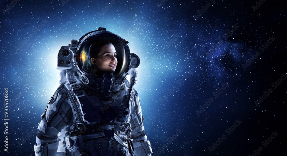 Wall mural attractive woman in spacesuit