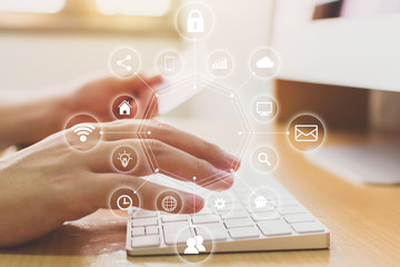 Hand holding credit card and using computer desktop with icon technology internet of things (IOT)....