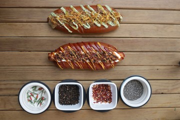 Hot dogs and species on a wooden table