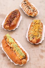 A variety of Hot Dogs in a wooden surface