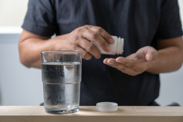 Sick  MAN medicines for sick pills spilling out of bottle