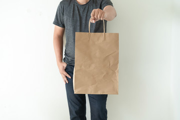 Fototapeta na wymiar Consumer pack product Man shows bag mock up show
