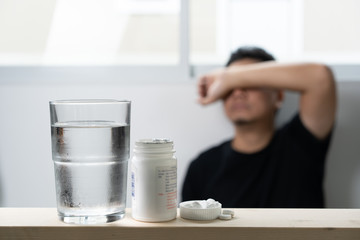 Sick  MAN medicines for sick pills spilling out of bottle